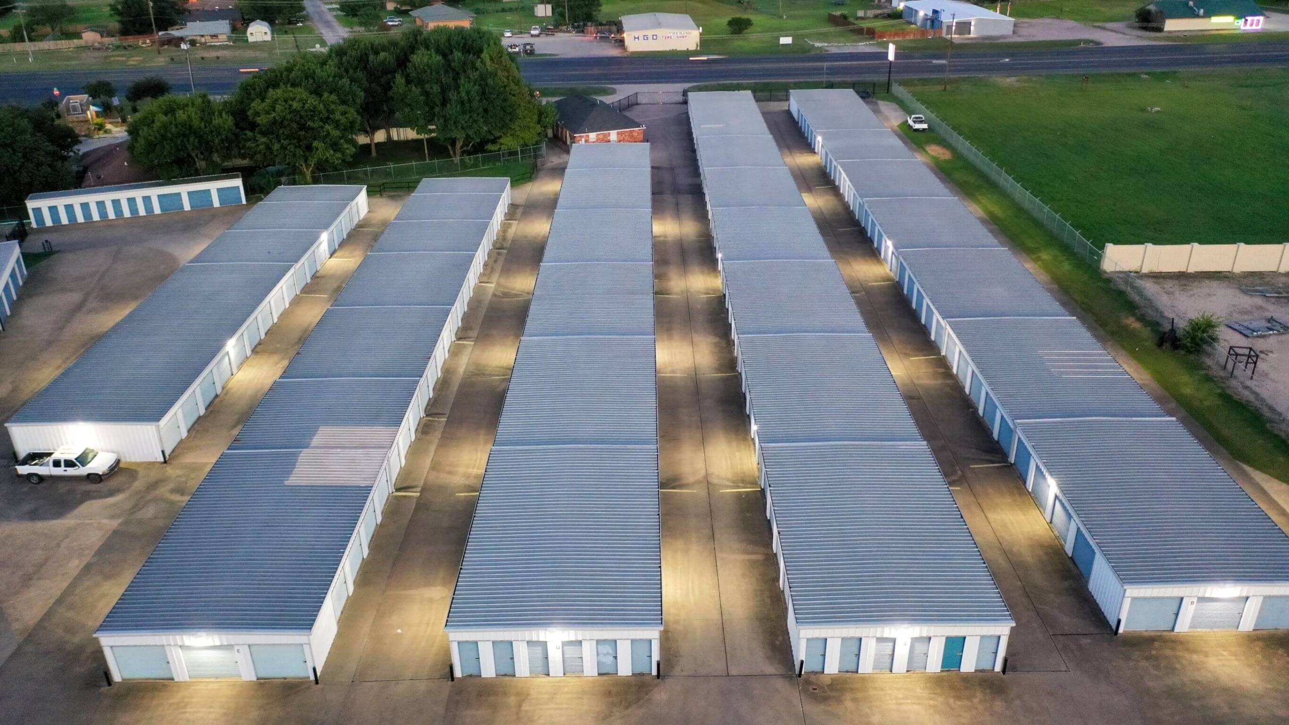 Bird's eye view of well lit storage rowsfrom rear of Joey's Self Storage in Waxahachie, TX